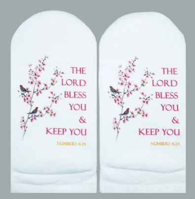 White socks featuring pink cherry blossoms, birds, and the Bible verse Numbers 6:24 in pink text.