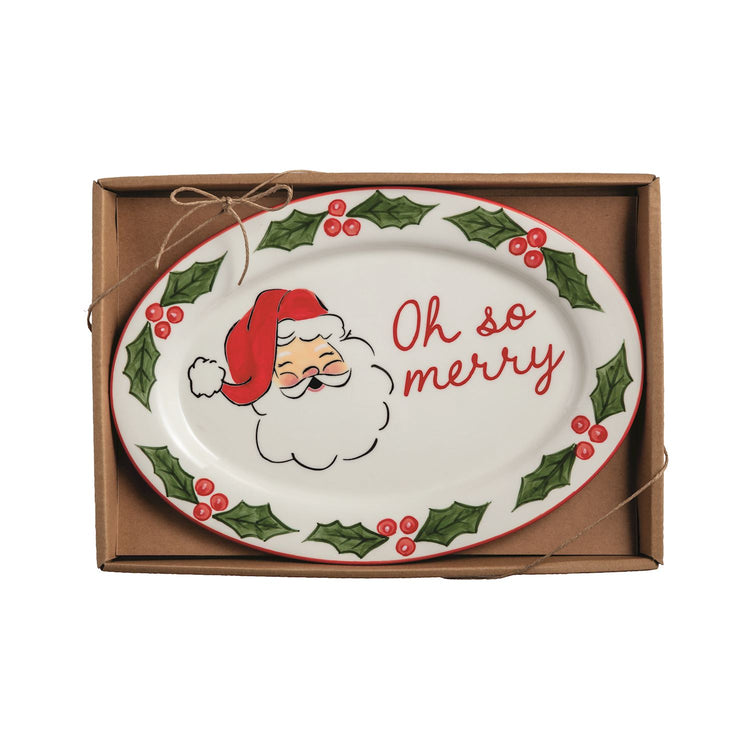 Oval ceramic plate in a box featuring Santa Claus and the text "Oh so merry" with holly borders.
