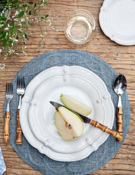 Berry & Thread Whitewash Flared Dessert/Salad Plate on a blue placemat with sliced pears.