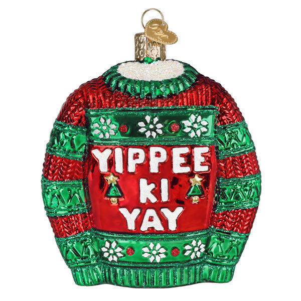 Glass Christmas ornament shaped like a red and green sweater with the text Yippee Ki Yay.