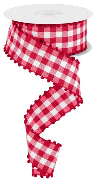 A spool of black checkered ribbon with attached pink pom-poms.