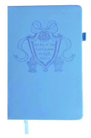 Light blue Standing On The Word Journal with a bow design and Nehemiah 8:10 scripture on the cover.