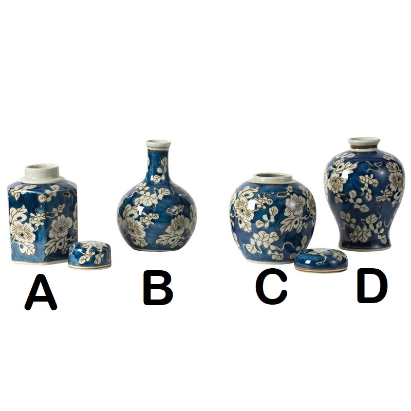 Ceramic vase with blue background, white floral print, gold accents, and graceful silhouette.