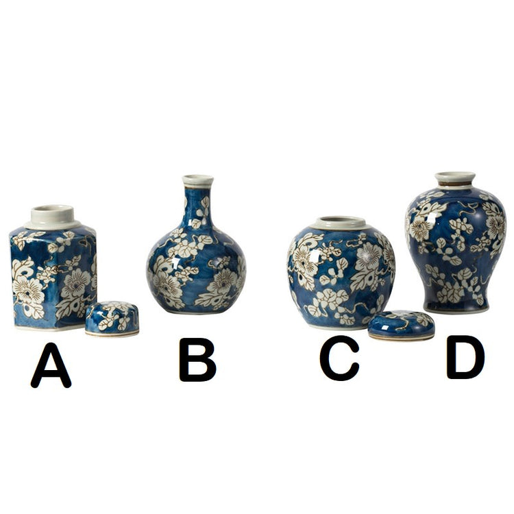 Ceramic vase with blue background, white floral print, gold accents, and graceful silhouette.