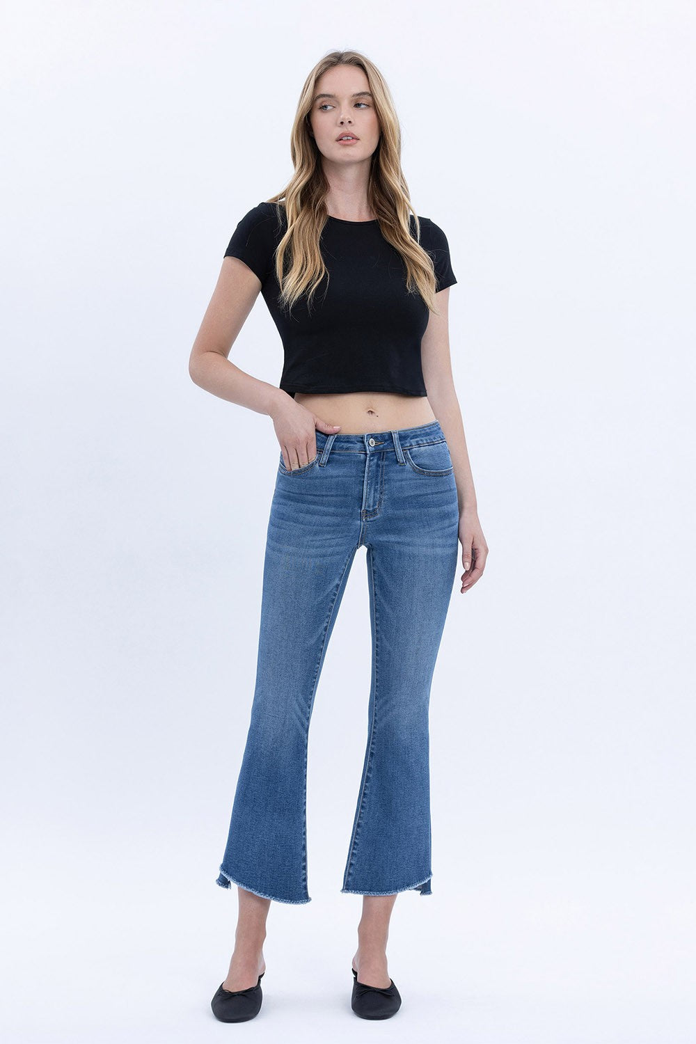 Women's mid-rise cropped flare jeans in stretch denim with a raw step hem.
