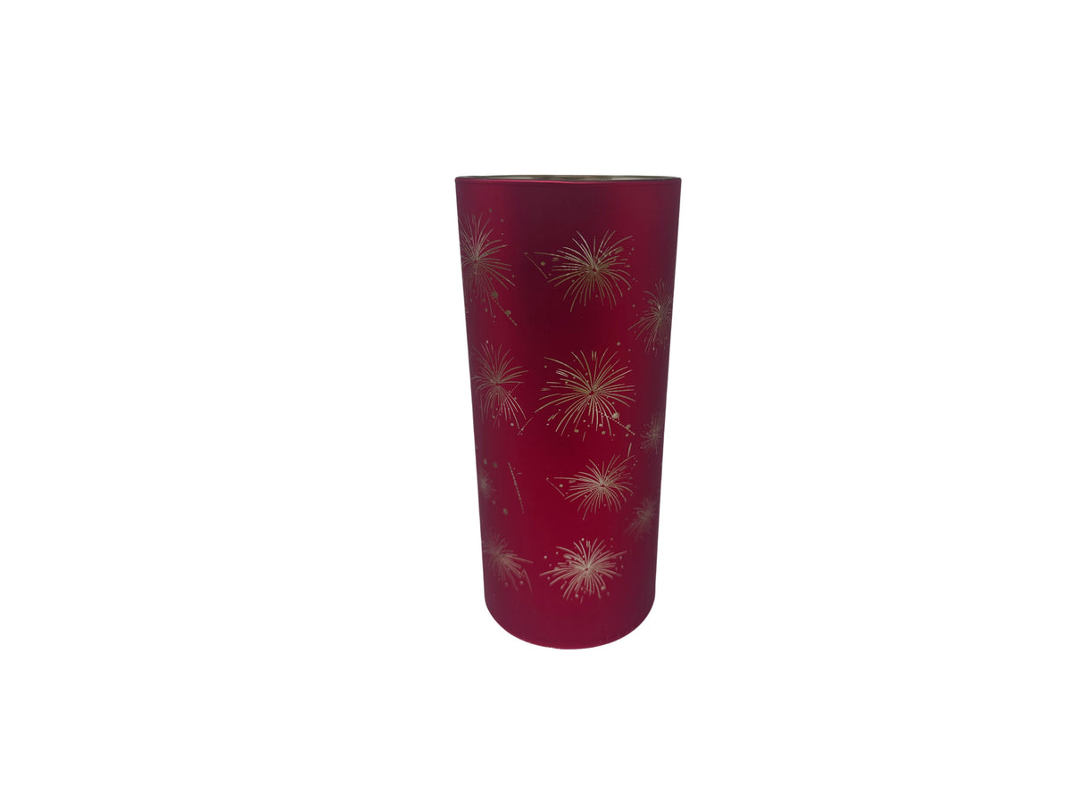 Tall red glass cylinder with gold starburst patterns and internal LED lighting.