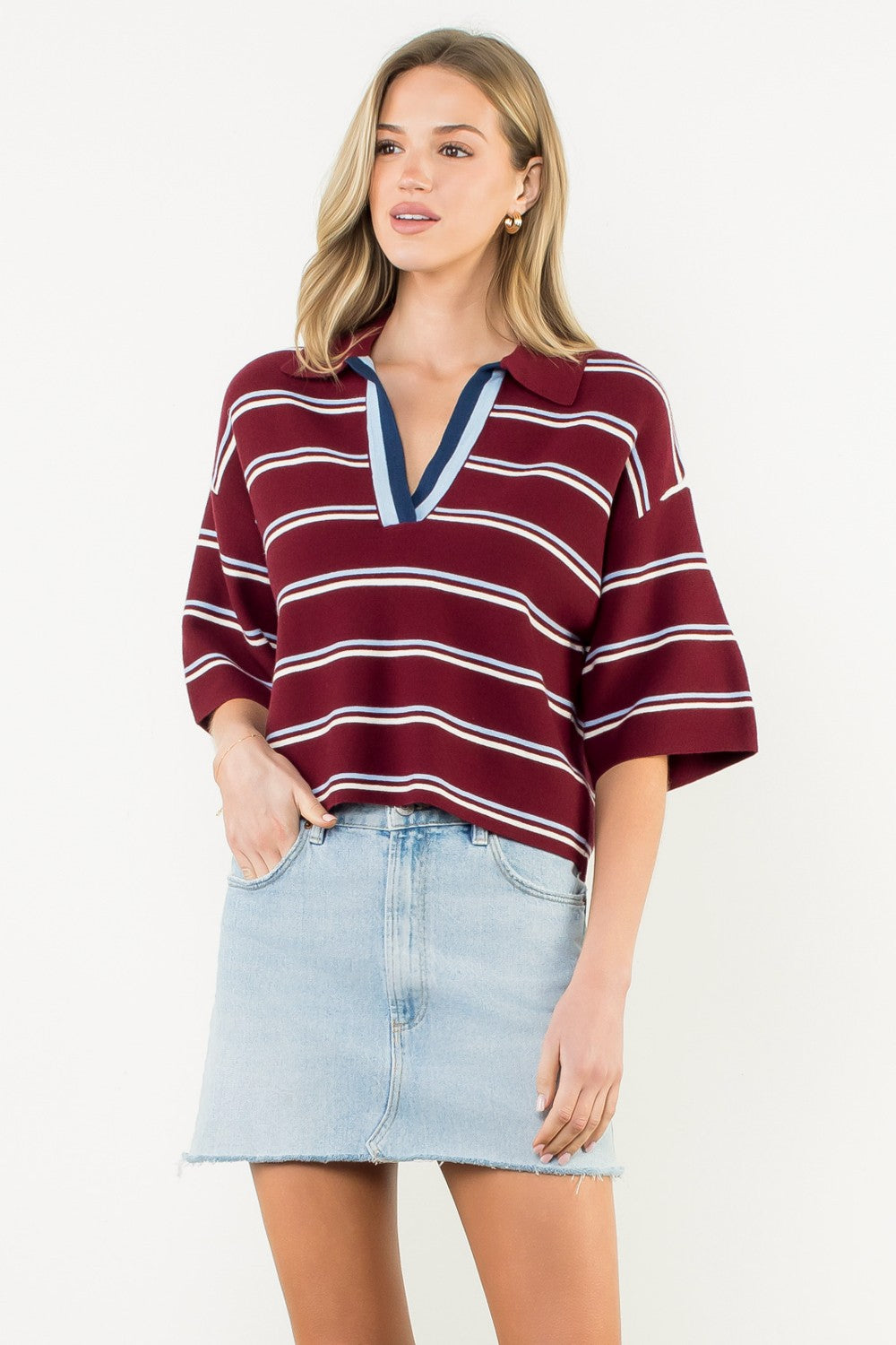 Woman wearing the Jasmine Short Sleeve Striped Knit Top in burgundy with a denim skirt.