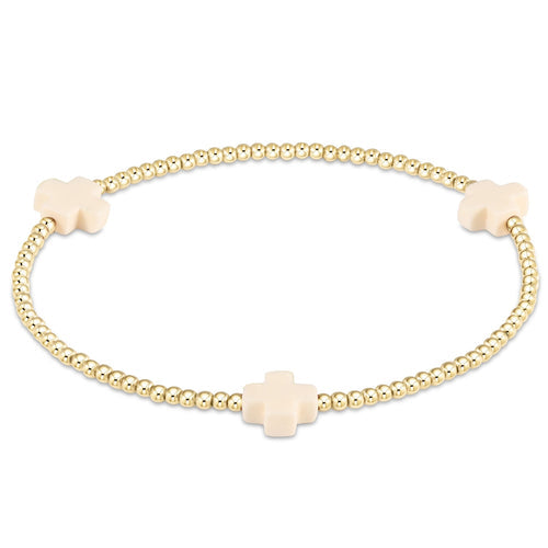 A gold-filled bracelet with a cross bead pattern on high-performance elastic.