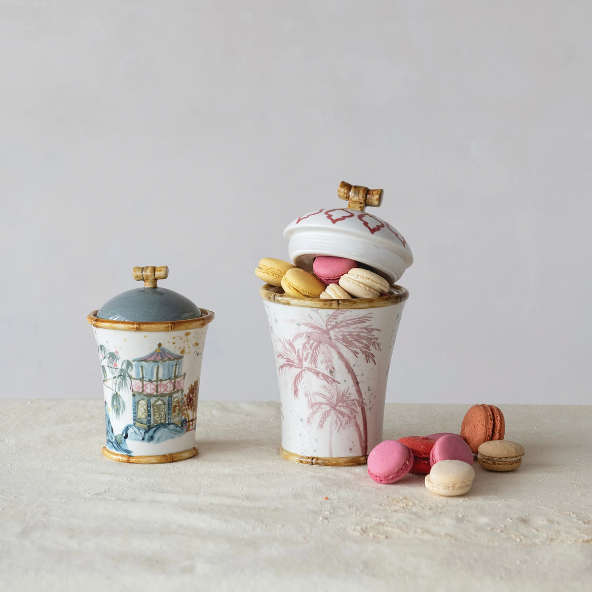 Round stoneware canister with hand-painted palm tree pattern and bamboo-style rim edges.