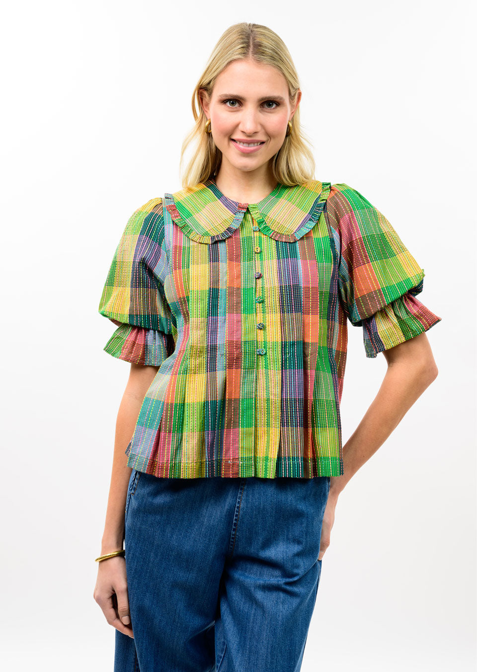 Woman wearing the Ivy Blocks Of Plaid Top with an oversized collar and puff sleeves.
