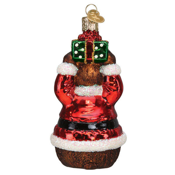 Christmas Bear ornament in red with white accents, black eyes, and a green scarf.