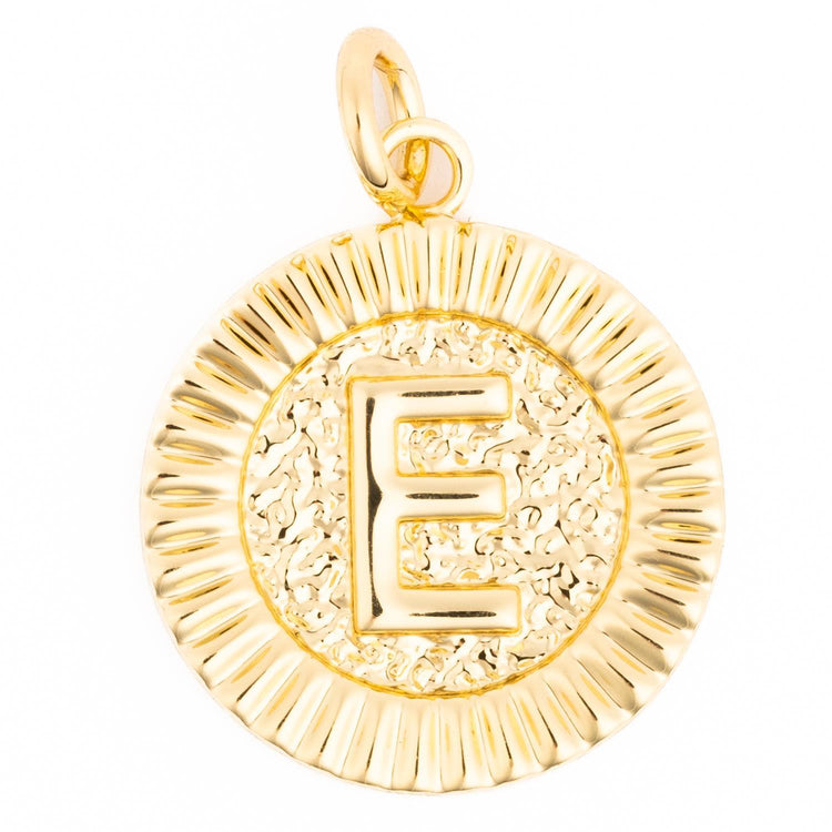 Gold round medallion charm with a raised letter E and textured background on a fluted border.