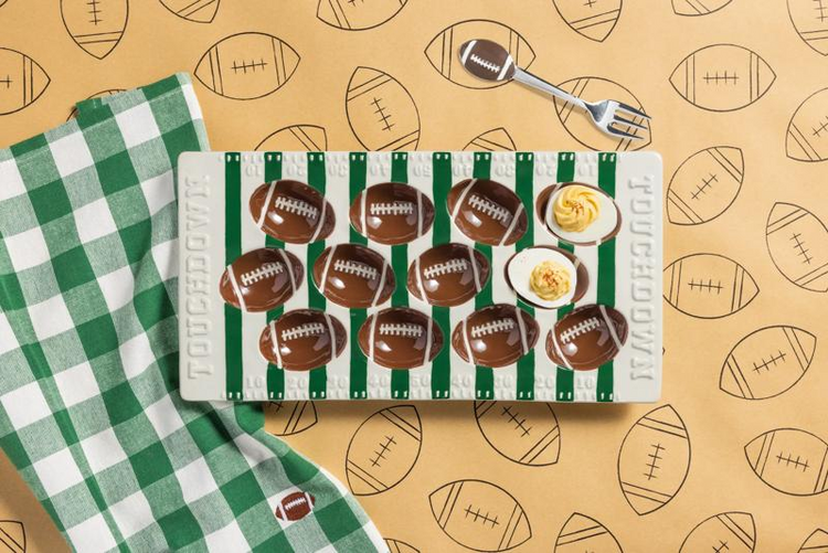 Football Field Deviled Egg Tray Set with a ceramic platter, matching fork, and green checkered towel