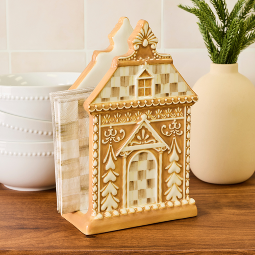 Mocha Check Gingerbread Napkin Holder made of dolomite on a wooden surface with white bowls.