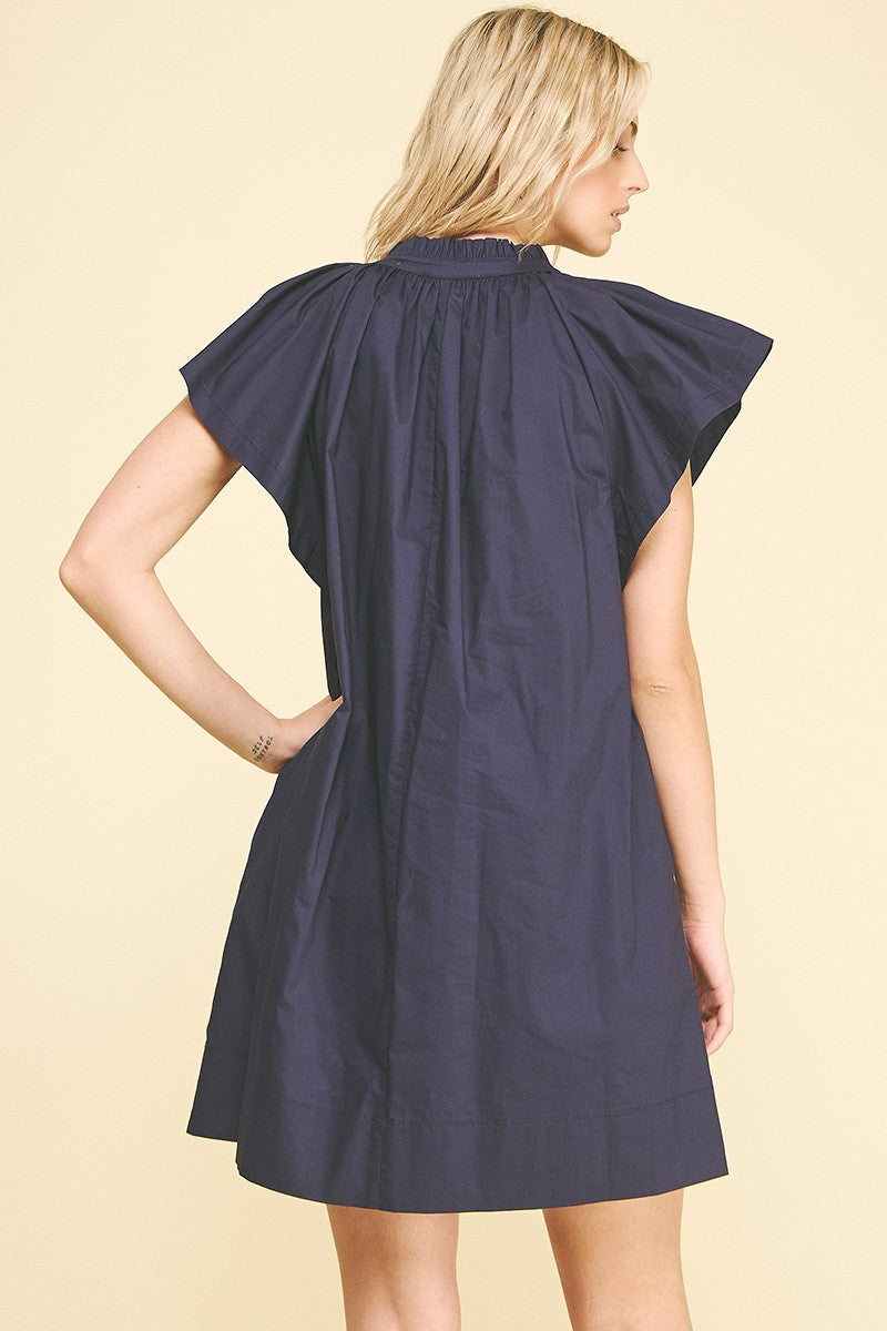 Amelia ruffle mini dress in white cotton with a flared silhouette.