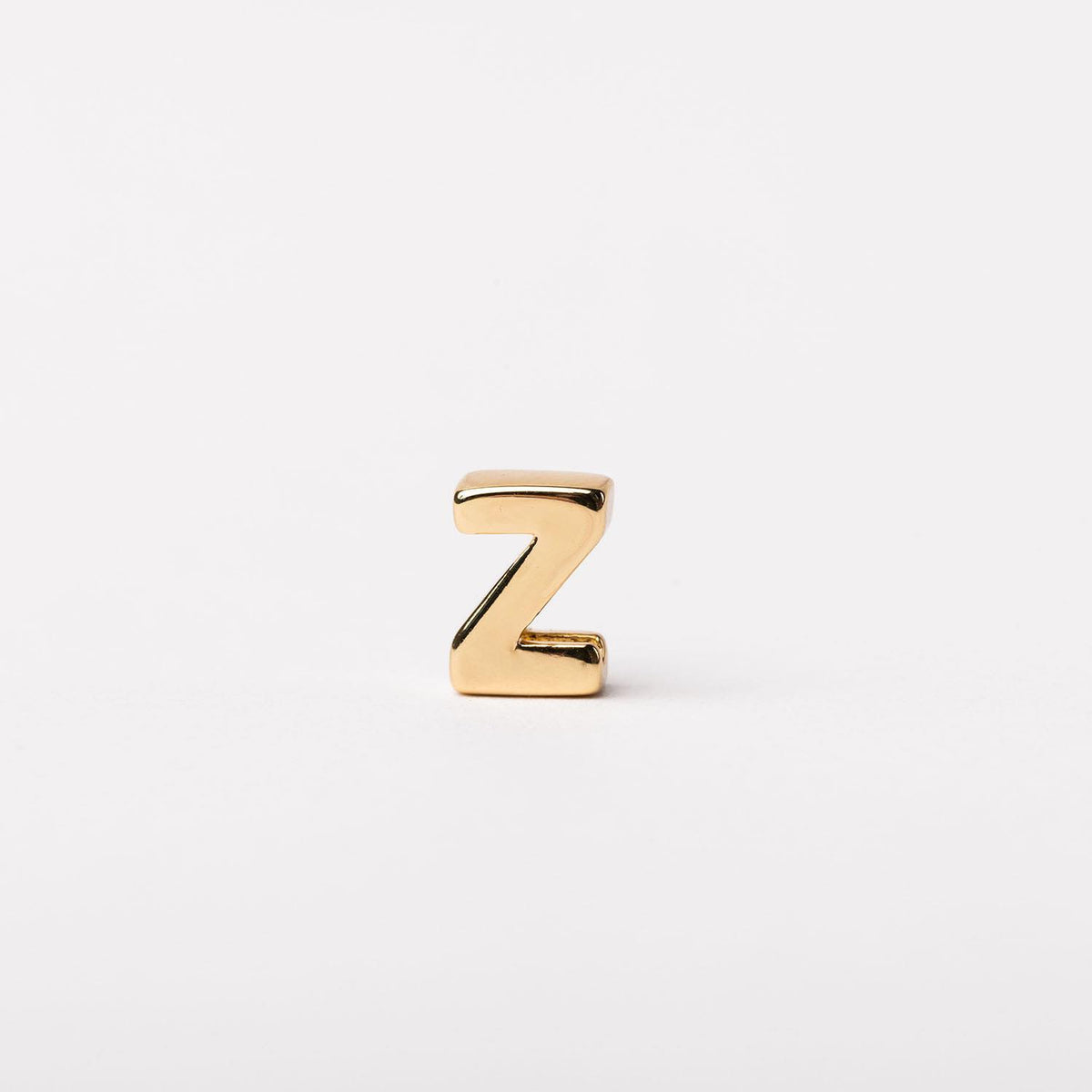 Gold-tone bar necklace with a delicate chain featuring small charm accents.