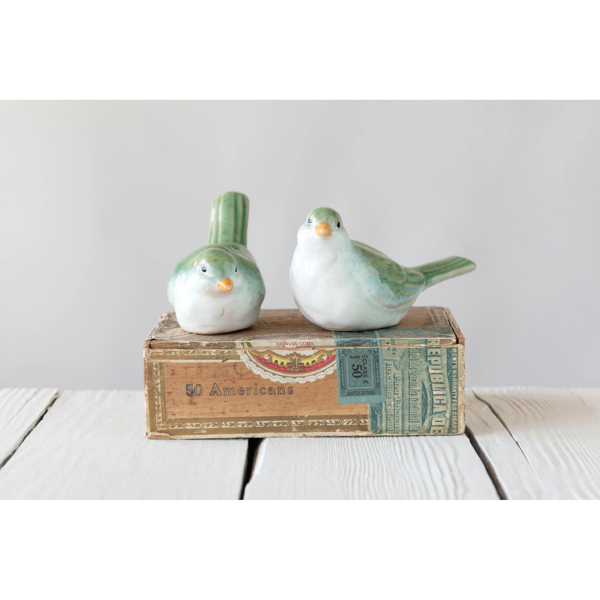 Stoneware bird figurine in natural earth tones with a smooth matte finish.