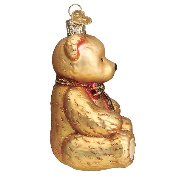 Gold glass teddy bear ornament with a red and green glittery bow and a heart-shaped tag.
