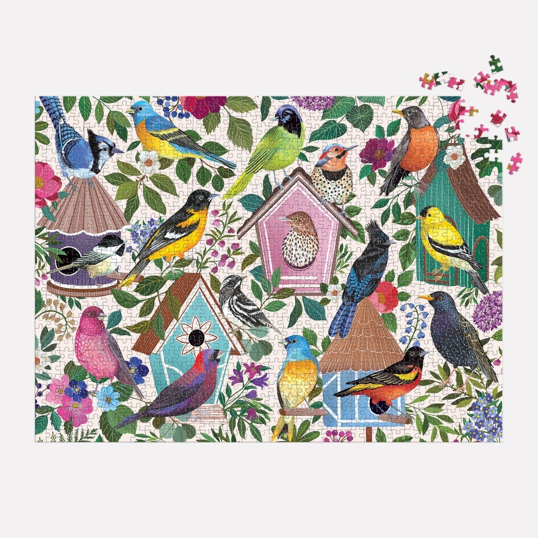 A 1000-piece puzzle featuring a colorful illustration of various birds perched on and around birdhouses amidst foliage and flowers.