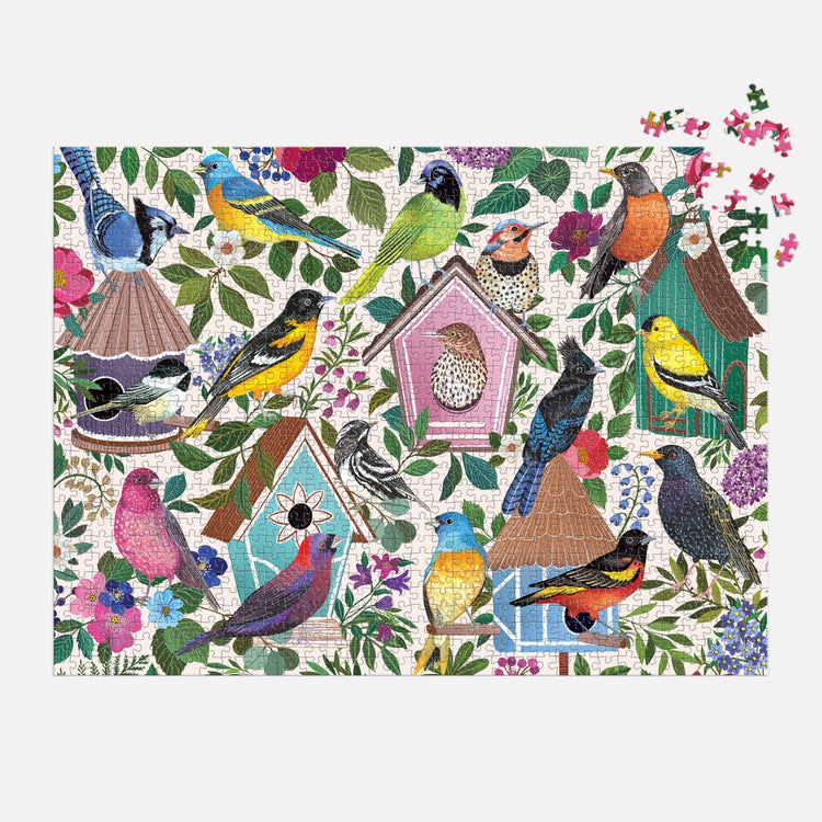 A 1000-piece puzzle featuring a colorful illustration of various birds perched on and around birdhouses amidst foliage and flowers.
