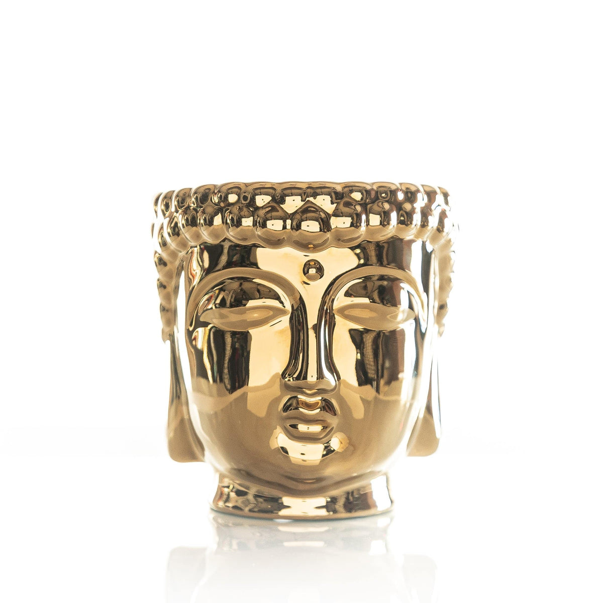 Gold Buddha candle in a cylindrical container with an ornate lid.
