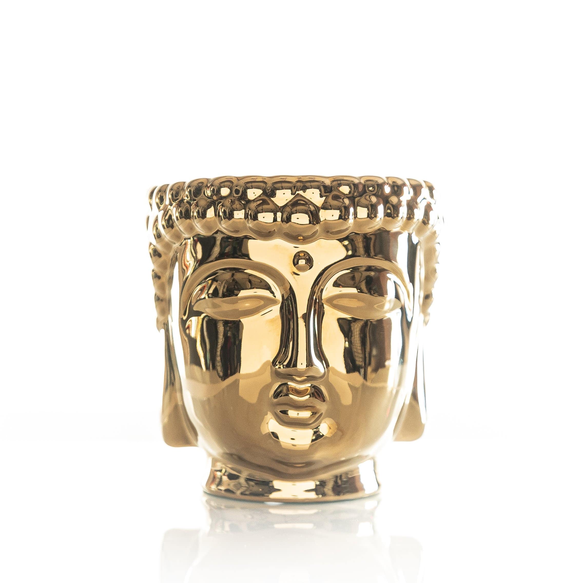 Gold Buddha candle in a cylindrical container with an ornate lid.