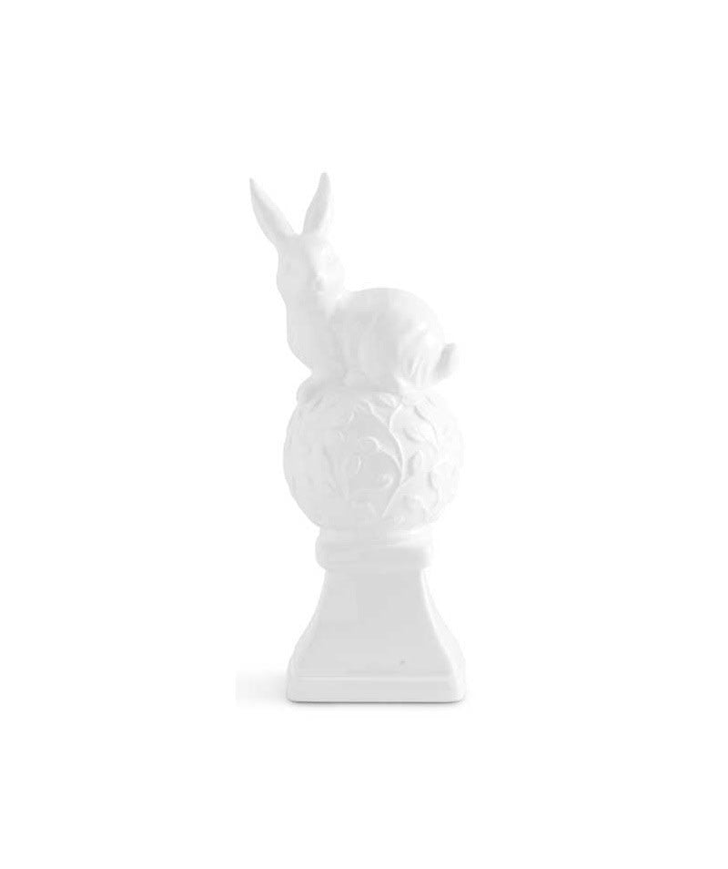 White ceramic finial shaped as two bunnies sitting on top.