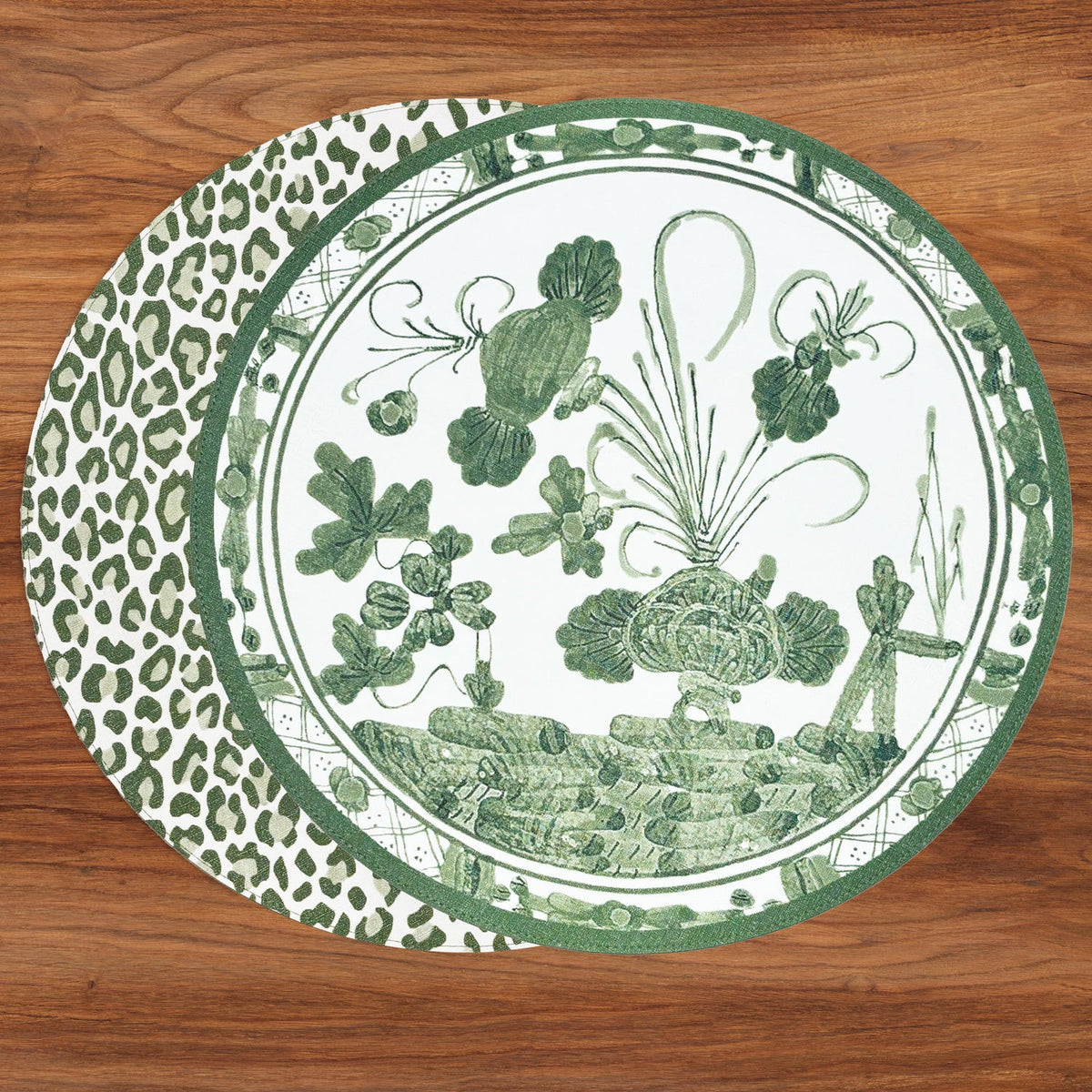 Set of 4 reversible round placemats featuring a green floral Faenza design and leopard print.
