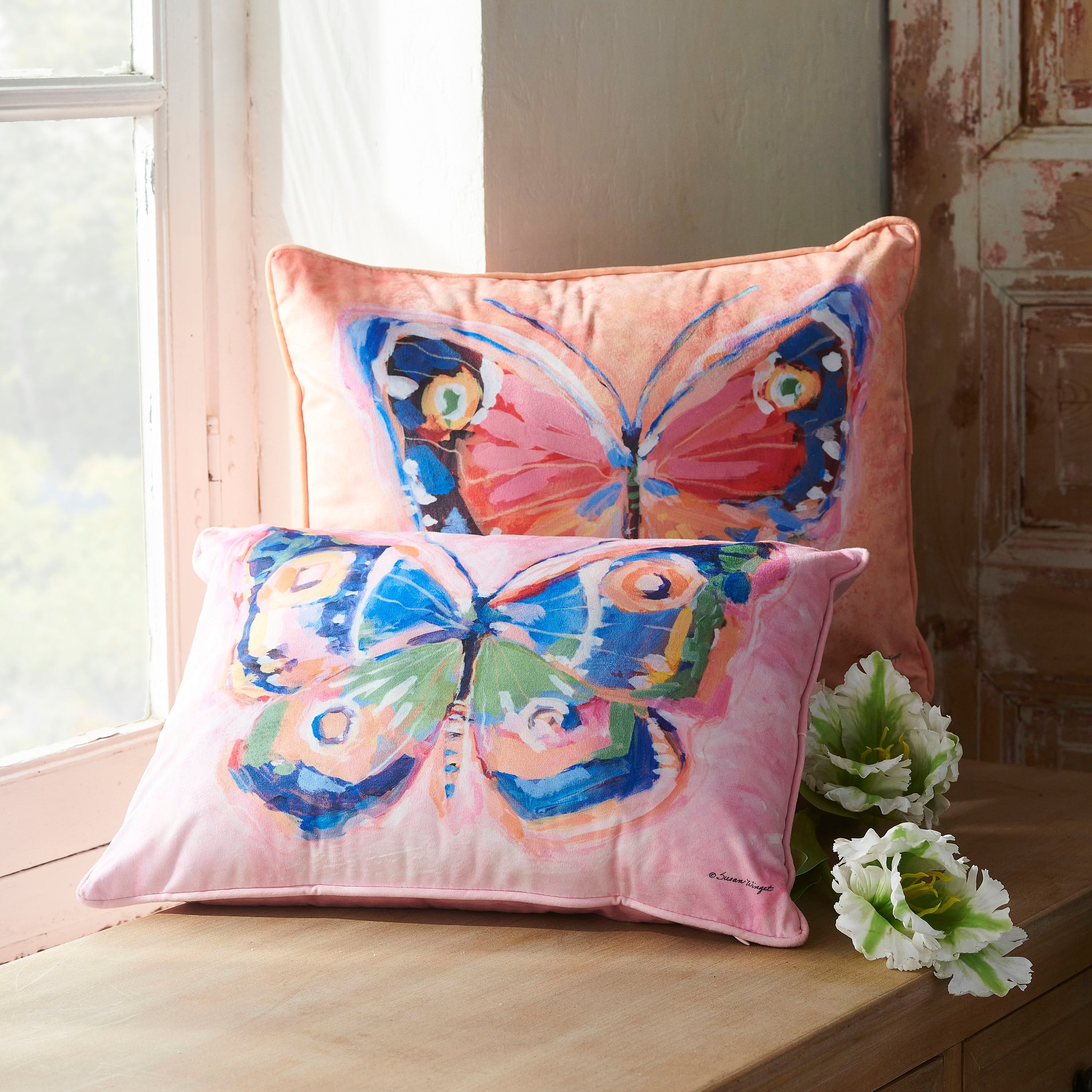 Square polyester pillow with a springtime floral print on the removable cover.