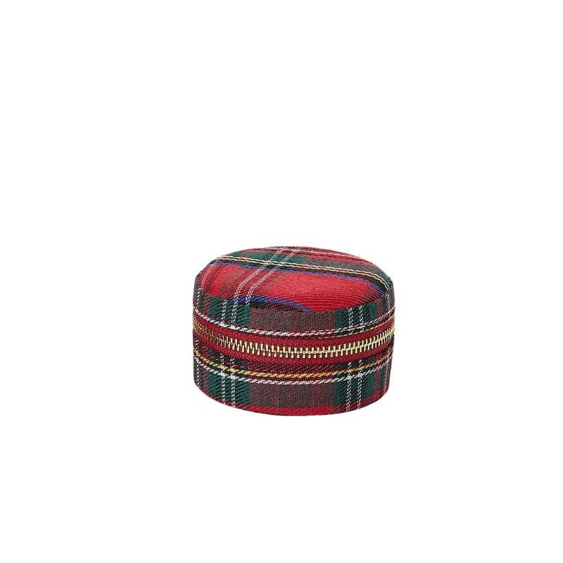 Small round red tartan jewelry box with a gold-tone zip-around closure.