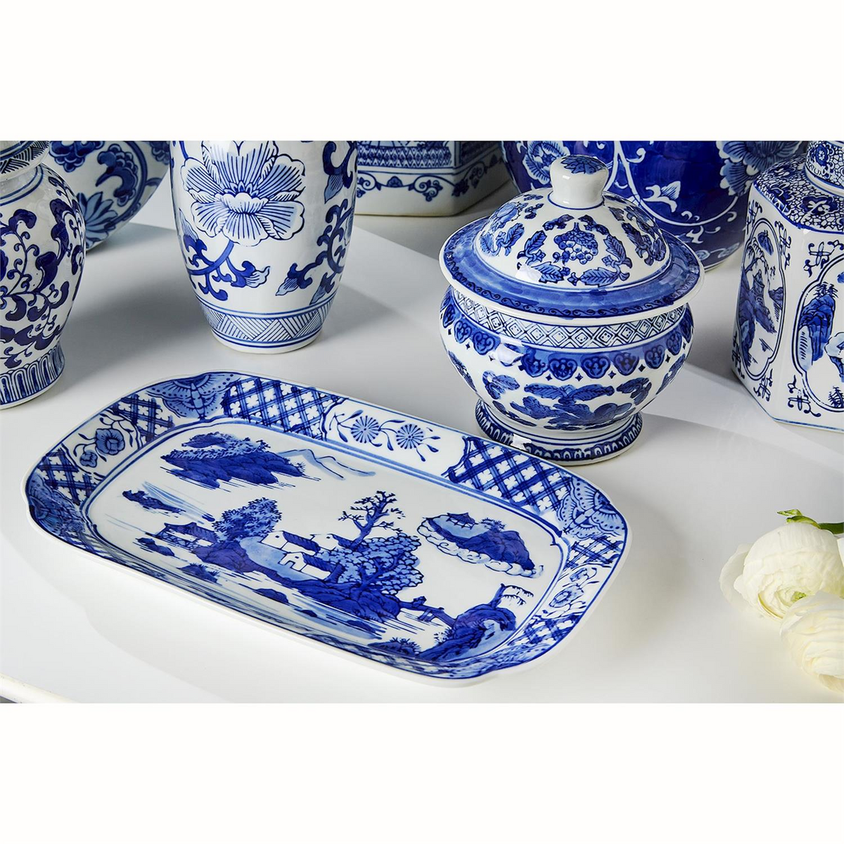 Assorted Canton blue and white ceramic home decor including a tray, ginger jars, and a lidded bowl.