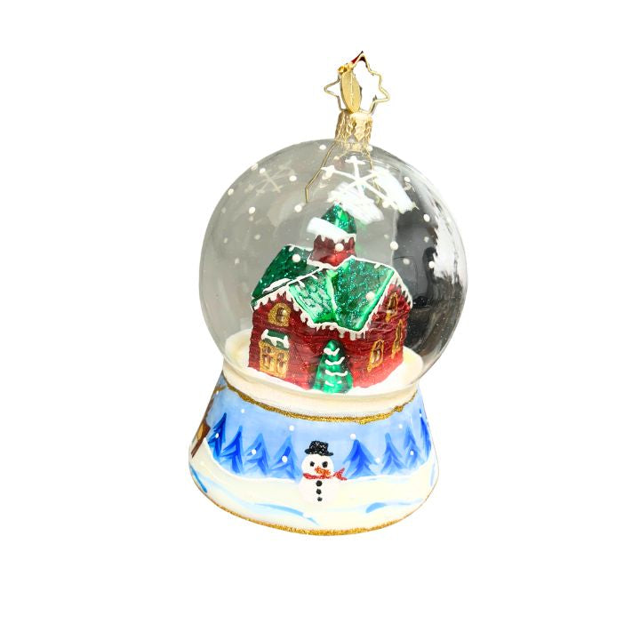 Handcrafted glass ornament with a red house in a winter dome and a painted snowman base.