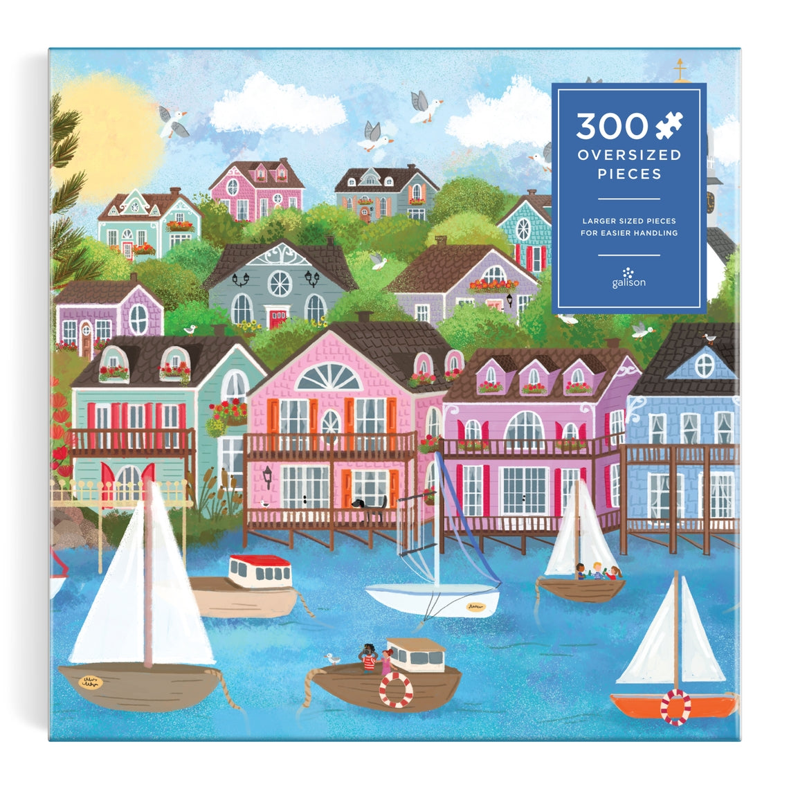 Joy Laforme Harbor By the Sea 300-piece puzzle featuring a coastal harbor scene with boats and water.