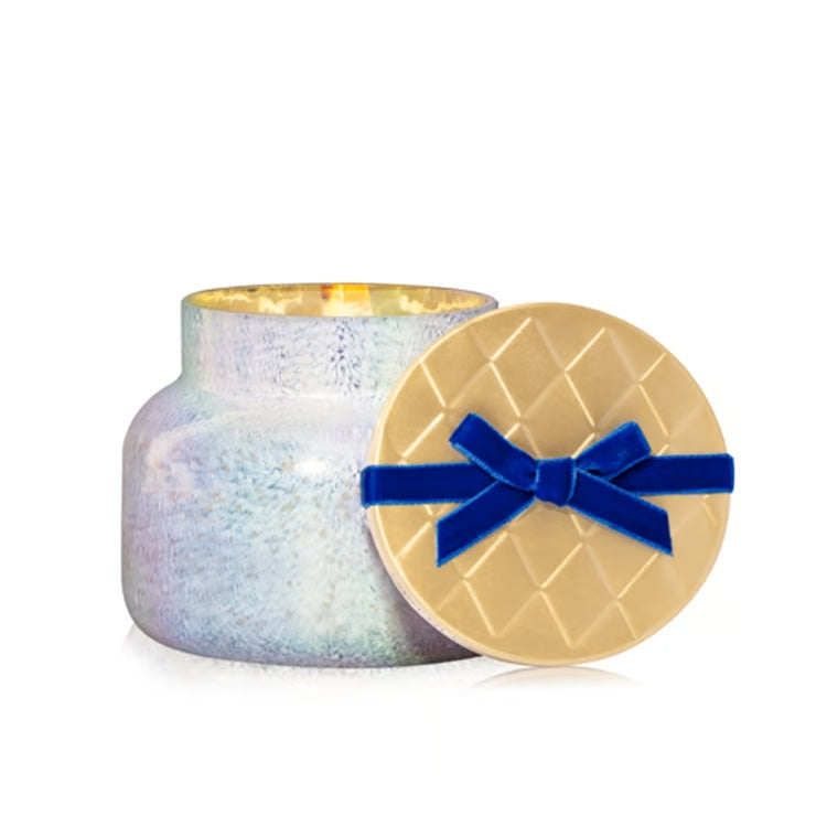 Volcano Artisan Winter Bazaar Signature Candle in iridescent jar with quilted gold lid and blue bow