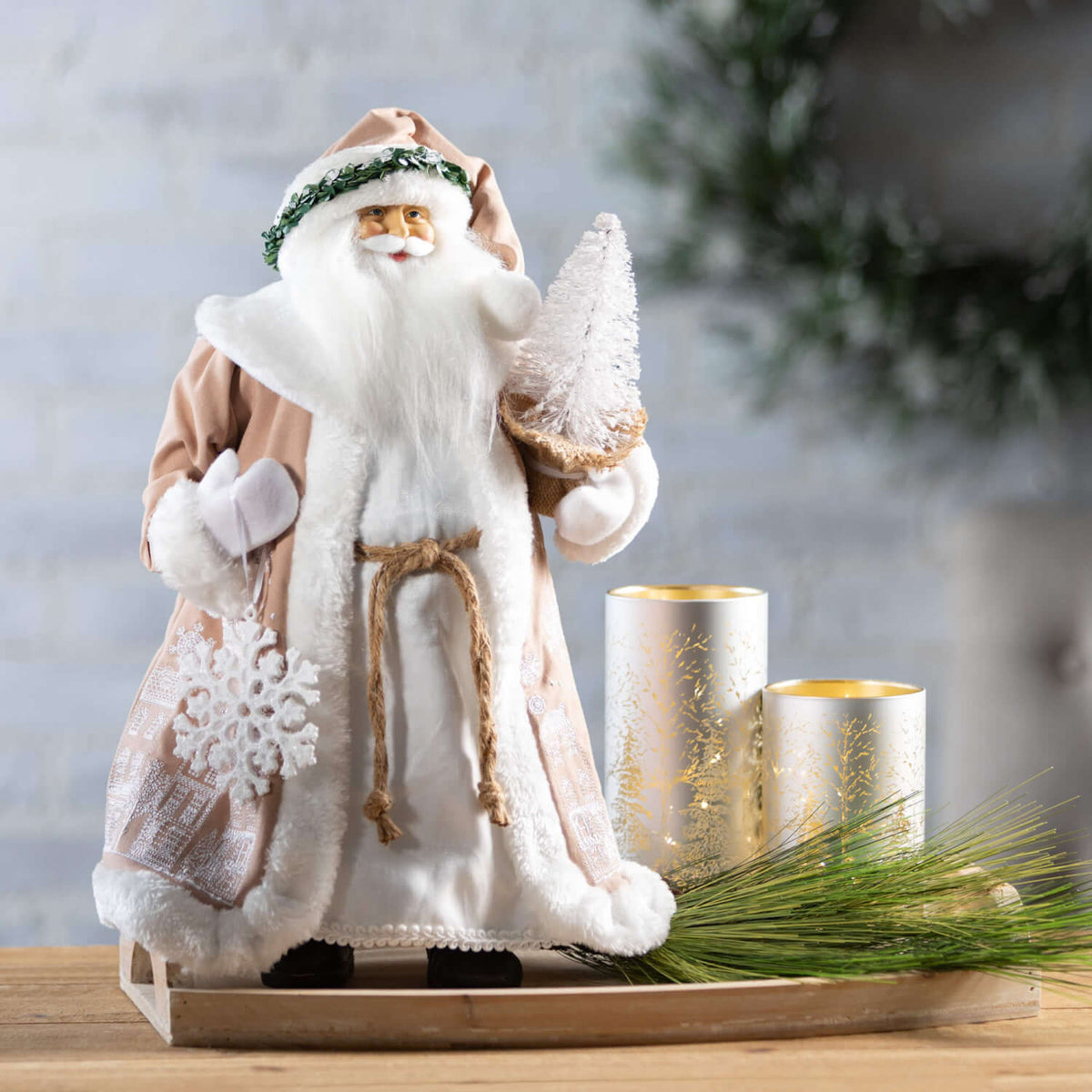 Winter Scene Lighted Cylinder Set of 3 with gold tree designs next to a Santa figurine.