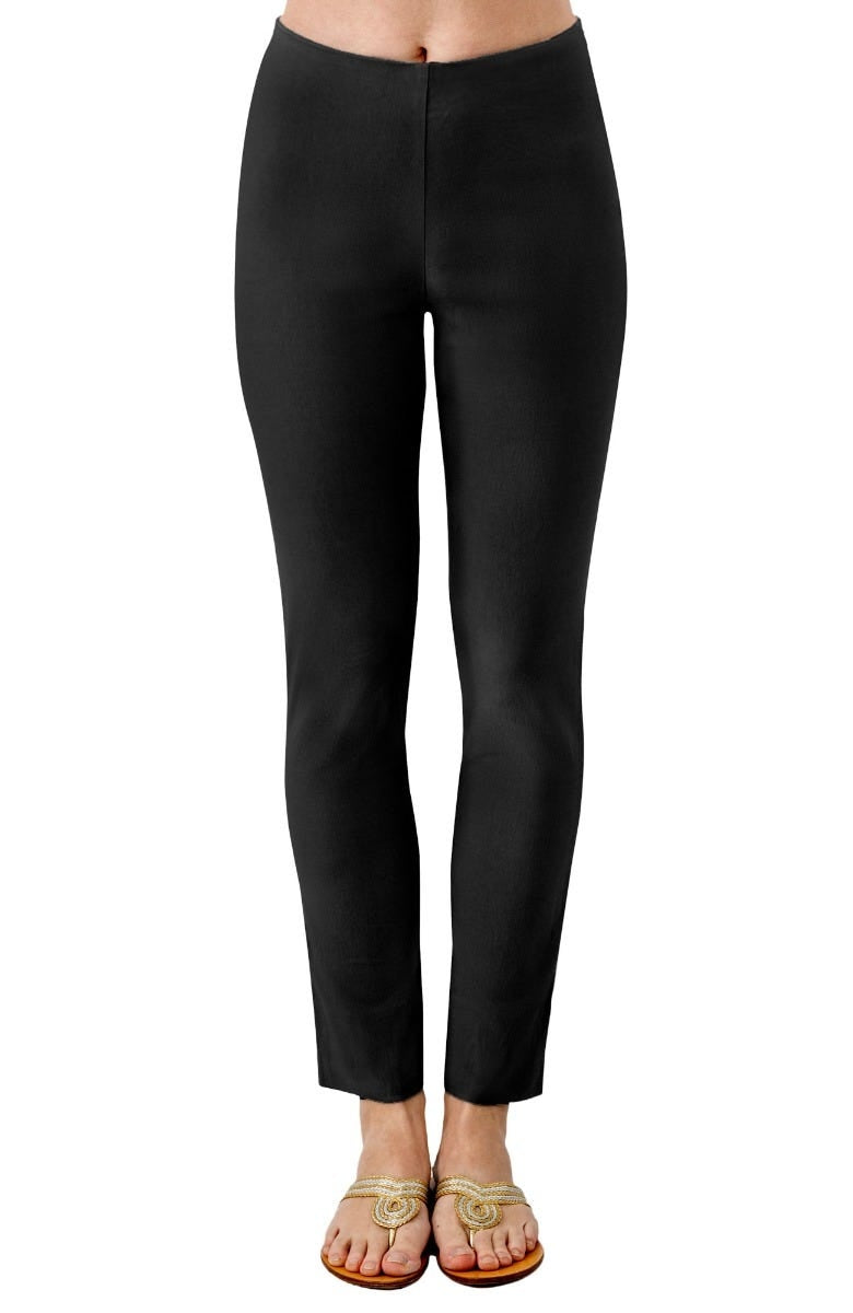 A person wearing black pull-on pants with a slim fit and ankle-length hem.