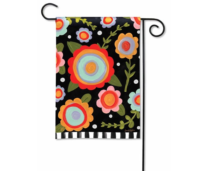Black garden flag with colorful folk art flowers and a black and white striped bottom border.
