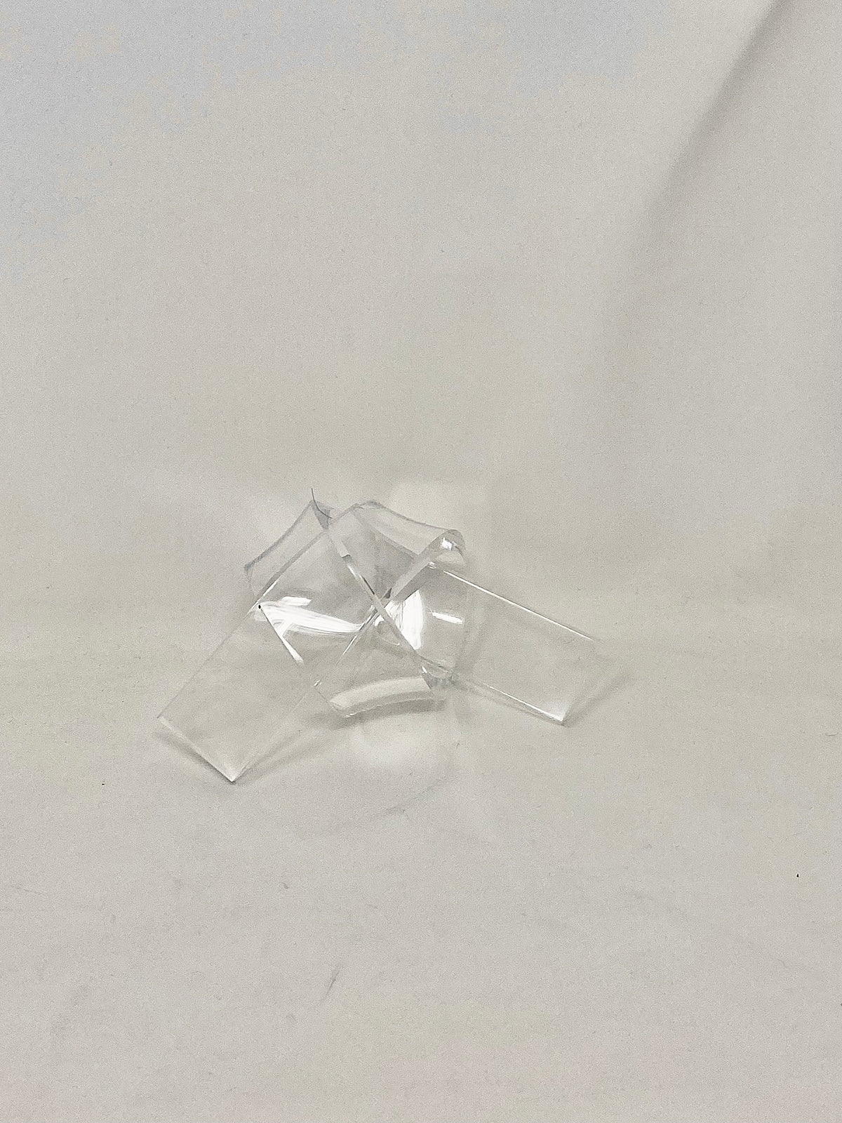 Acrylic knot pendant in clear acrylic with a silver-toned bail.