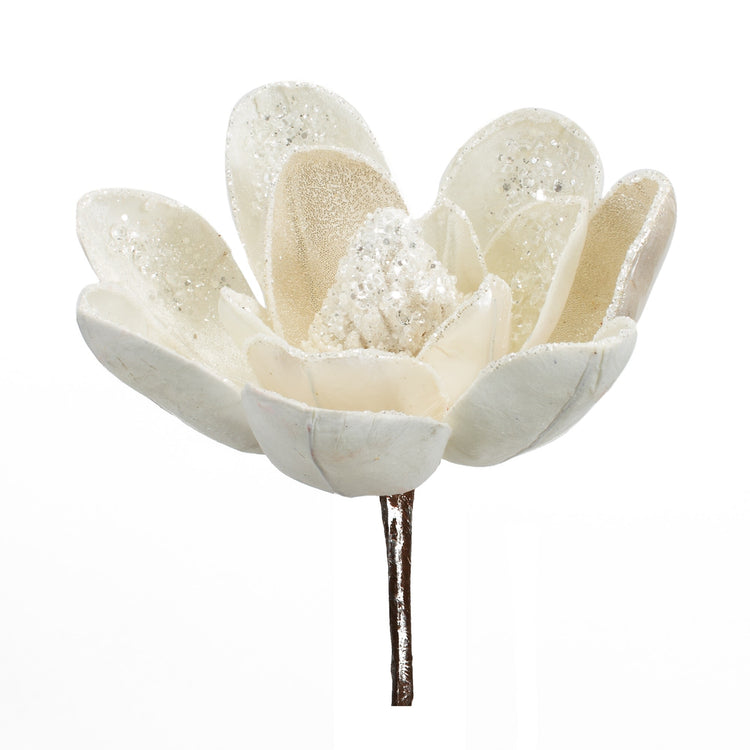 Artificial magnolia stem with soft velvety petals in cream color, realistic green leaves on a brown branch.