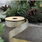 One-inch wide gold-silver lame micro dot fabric roll with a shimmering metallic pattern.
