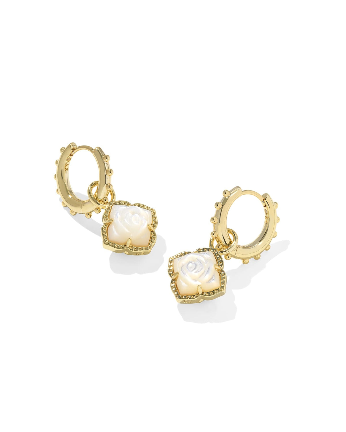 Gold huggie earrings with an ivory mother-of-pearl charm featuring a hinge closure.