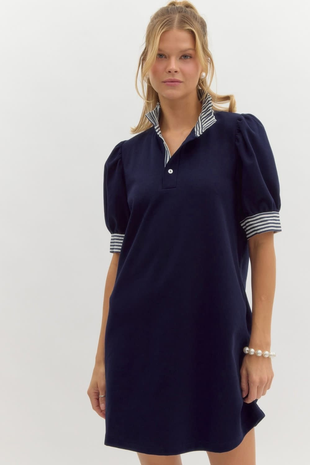 Front view of Mandy solid short-sleeve pullover polo dress in light blue knit fabric with ruffle neck and sleeve bands.