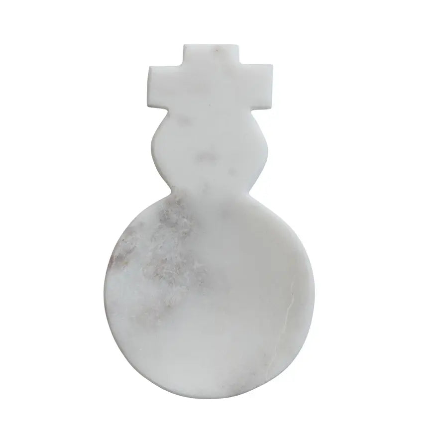 White marble spoon rest shaped like a snowman with black eyes and carrot nose.