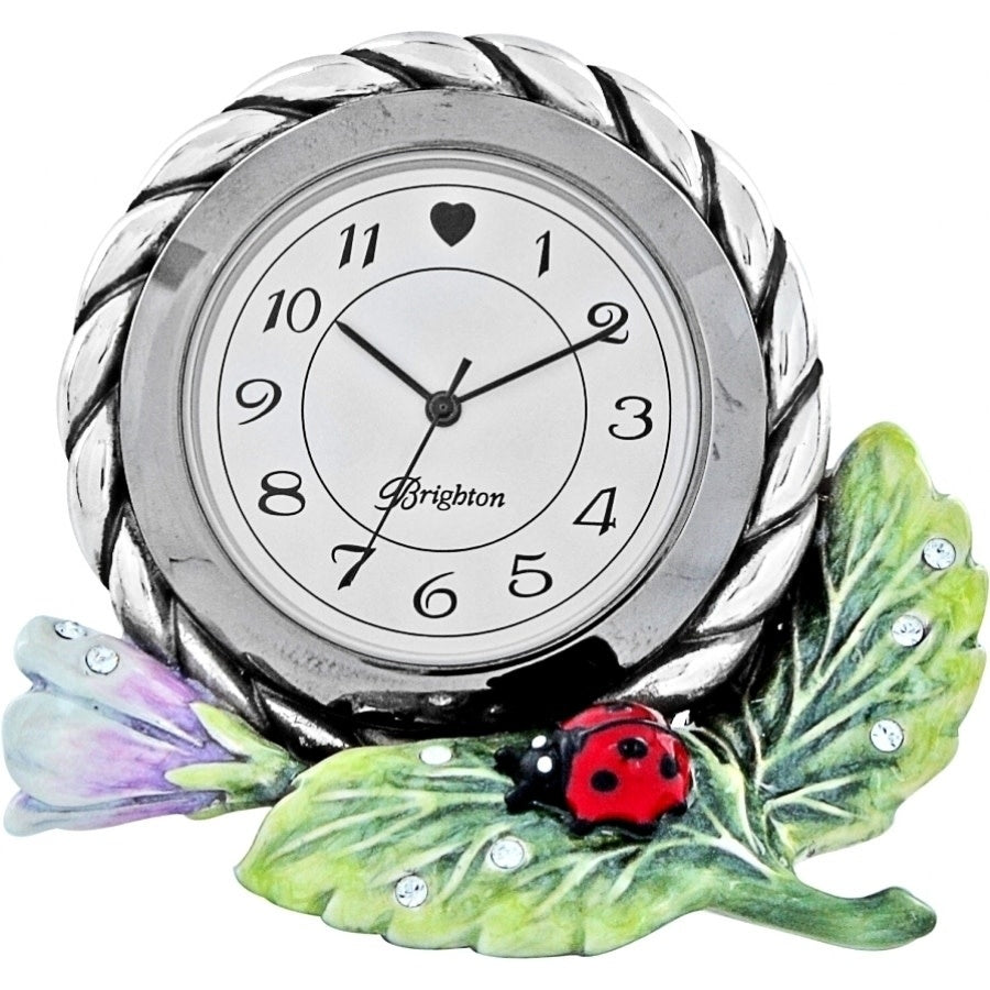 Multi-colored enamel clock with a swivel arm featuring nature-inspired marvels on the face.