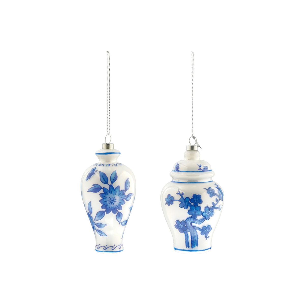 Two white glass ornaments shaped like ginger jars with blue hand-painted floral motifs.