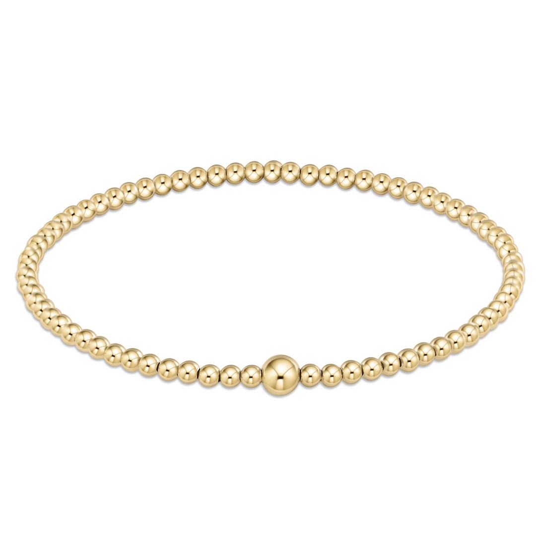 Classic gold 3mm bead bangle with a single larger gold bead accent on a hard wire.