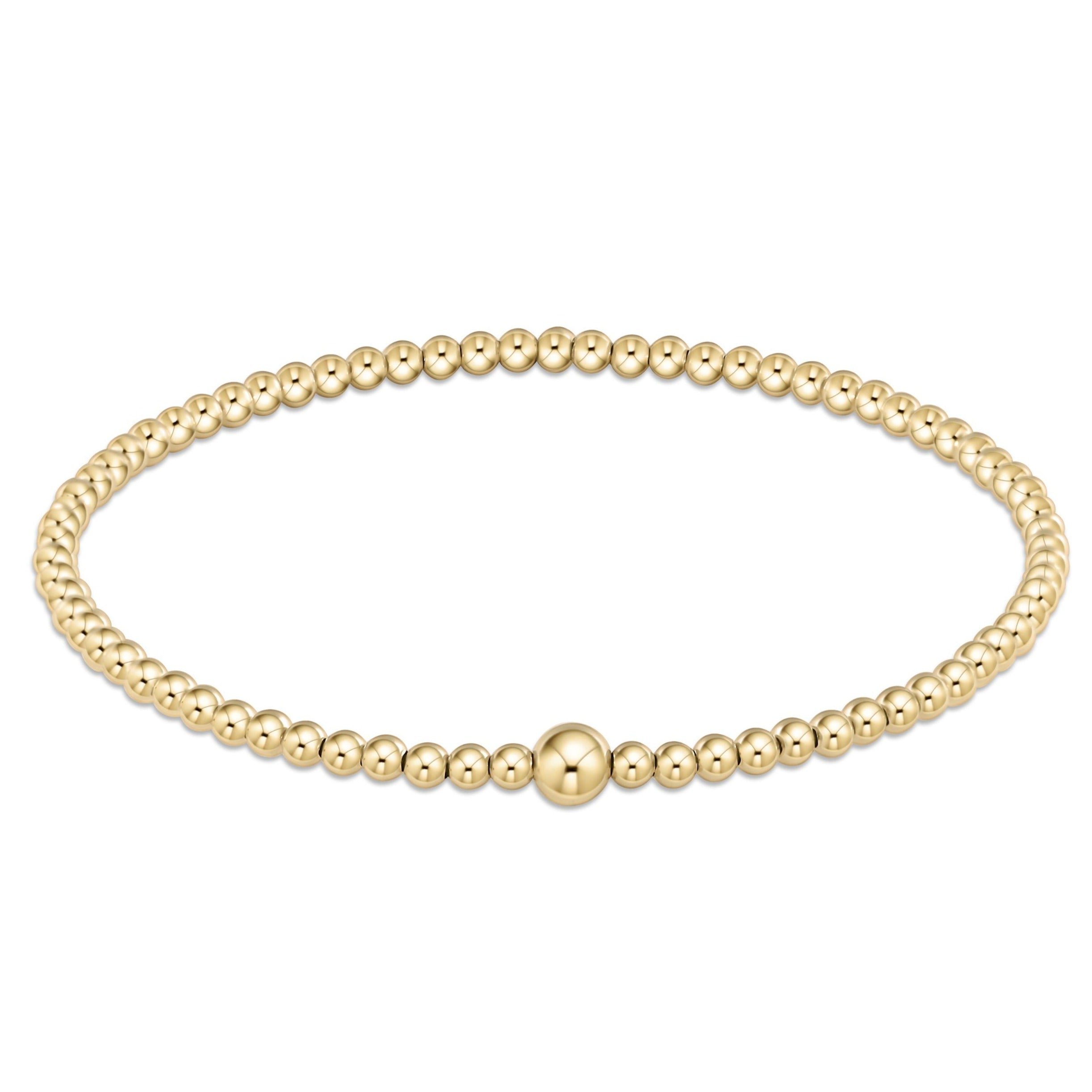 Classic gold 3mm bead bangle with a single larger gold bead accent on a hard wire.