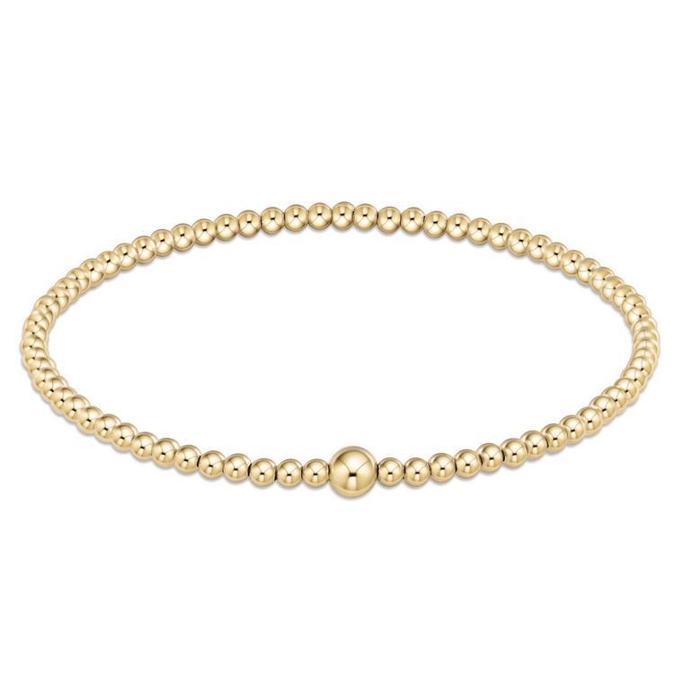 Classic gold 3mm bead bangle with a single larger gold bead accent on a hard wire.