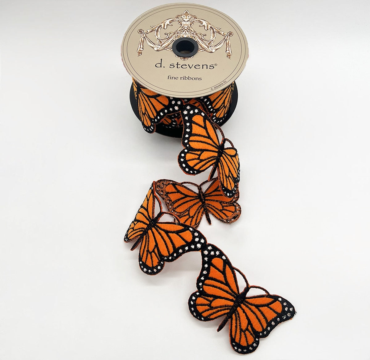 Orange felt garland with black ribbon featuring embroidered monarch butterfly silhouettes