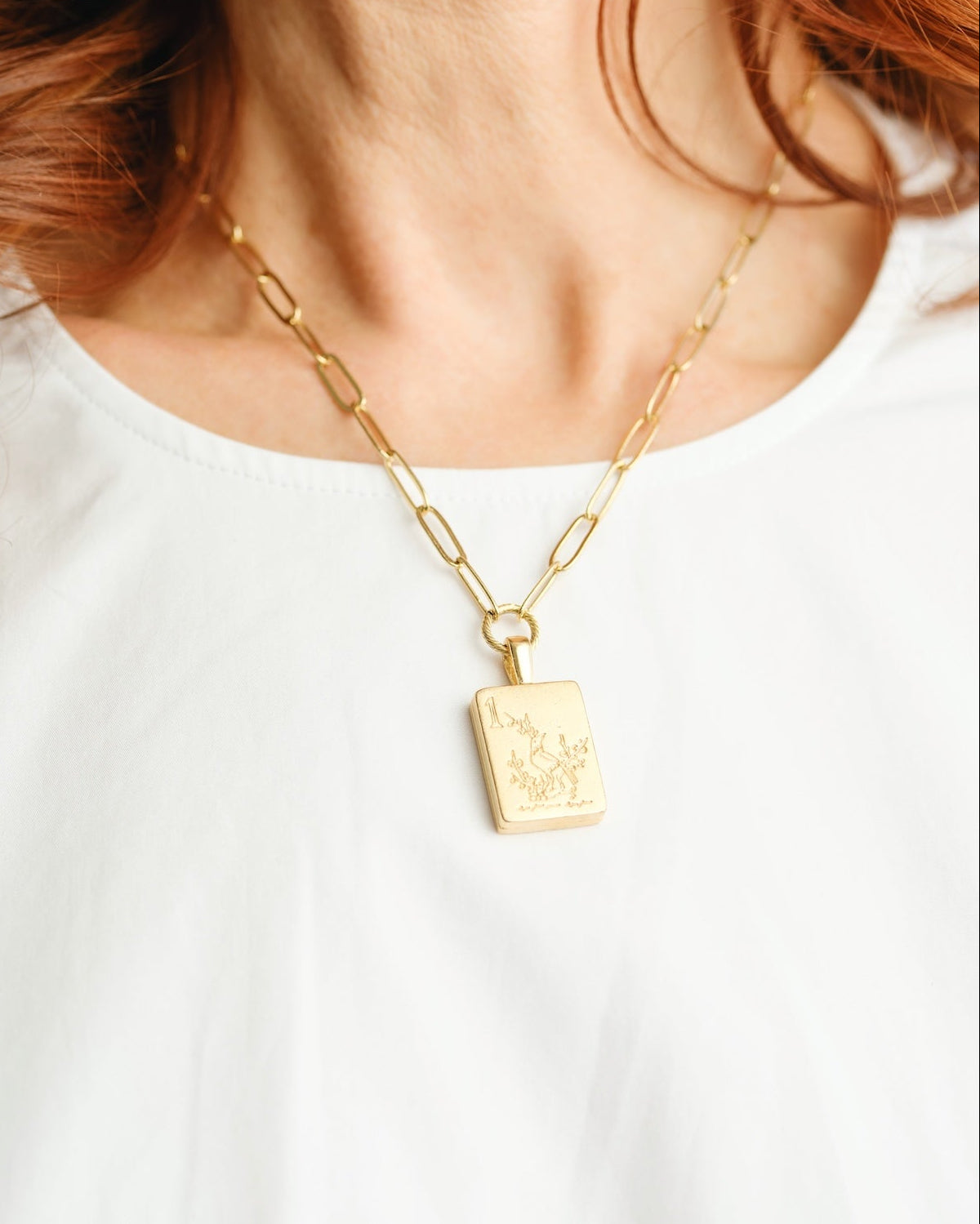 Bird Bam Mahjong medium paperclip necklace in gold-tone metal with a small bird charm.